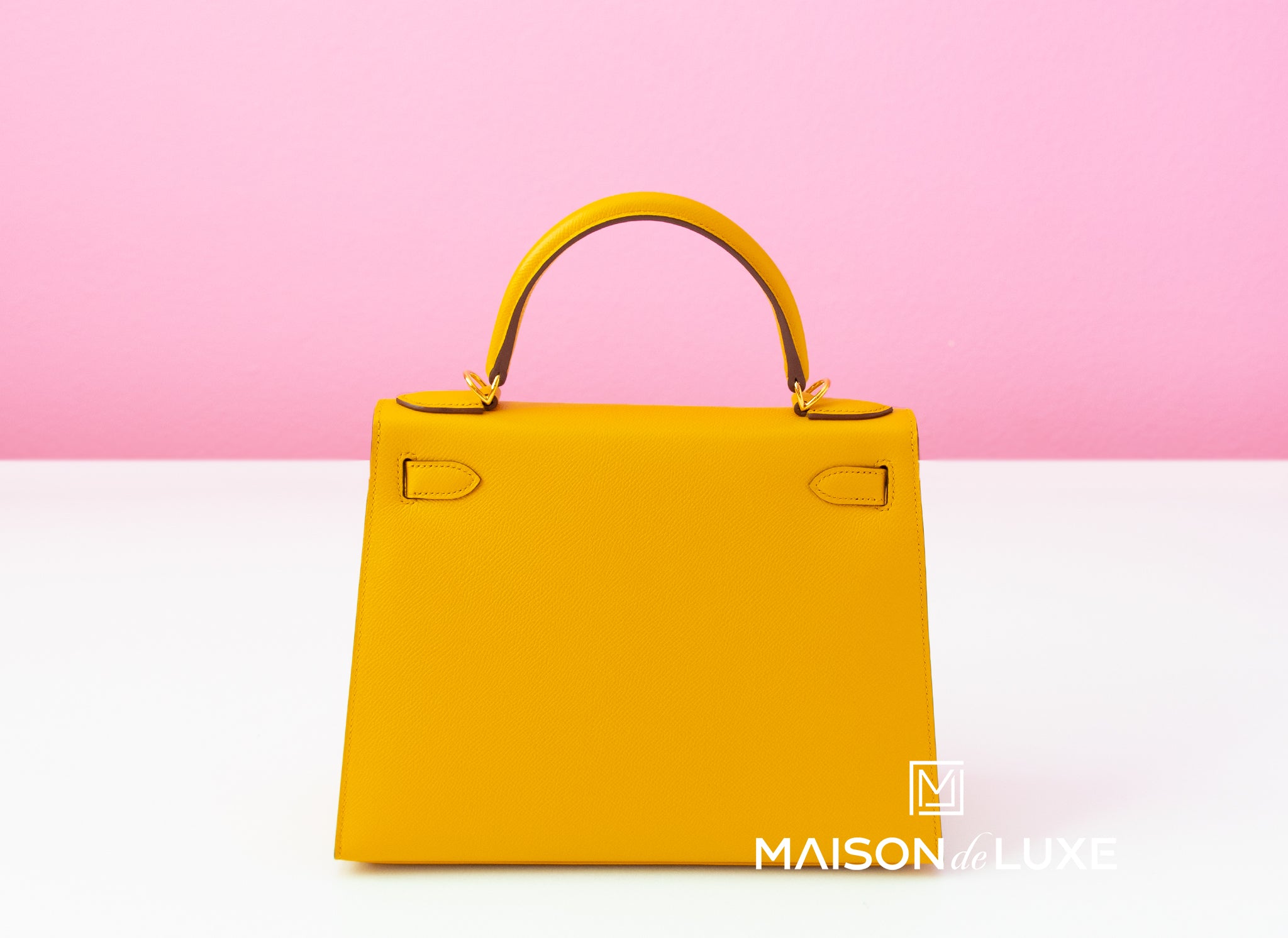 This stunning Hermès Kelly 28cm bag is featured in Jaune Ambre color. This  bag is made from Epsom leather, which is very sof…